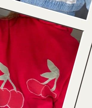 A red hoodie with an appliqued cherry design