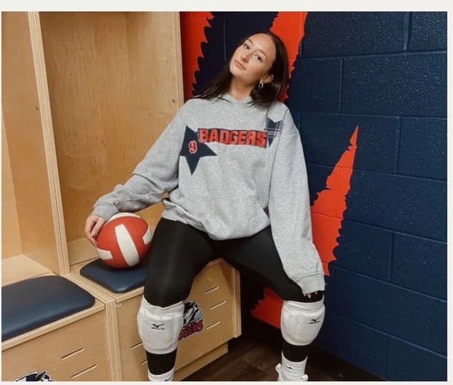 A grey Badgers crewneck in the locker room